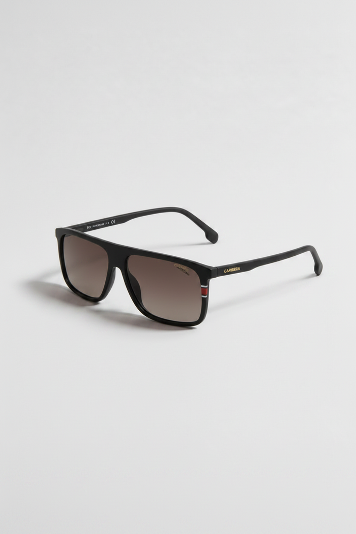 A pair of square-frame sunglasses with a matte black frame and brown tinted lenses, shown on a light gray background. The brand name 'BURGA' is visible in gold lettering on the temple arm.