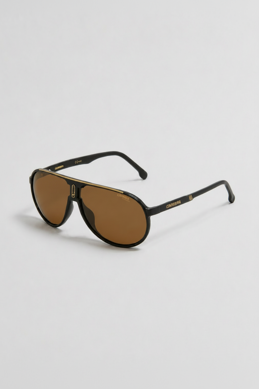 A pair of aviator-style sunglasses with a glossy black frame and warm brown lenses, shown on a light gray background.