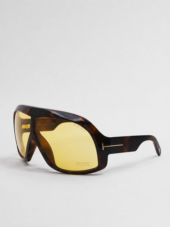 Tom Ford oversized shield sunglasses with a tortoiseshell acetate frame and yellow mirrored lenses, shown on a light gray background.